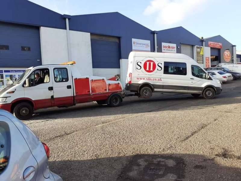 recovery truck pulling a van