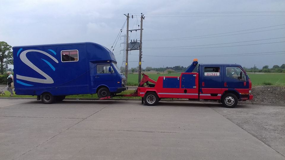 trailer being pulled by a recovery truck