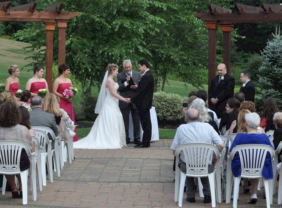 wedding ceremony at the trellis at Atkinson Country Club