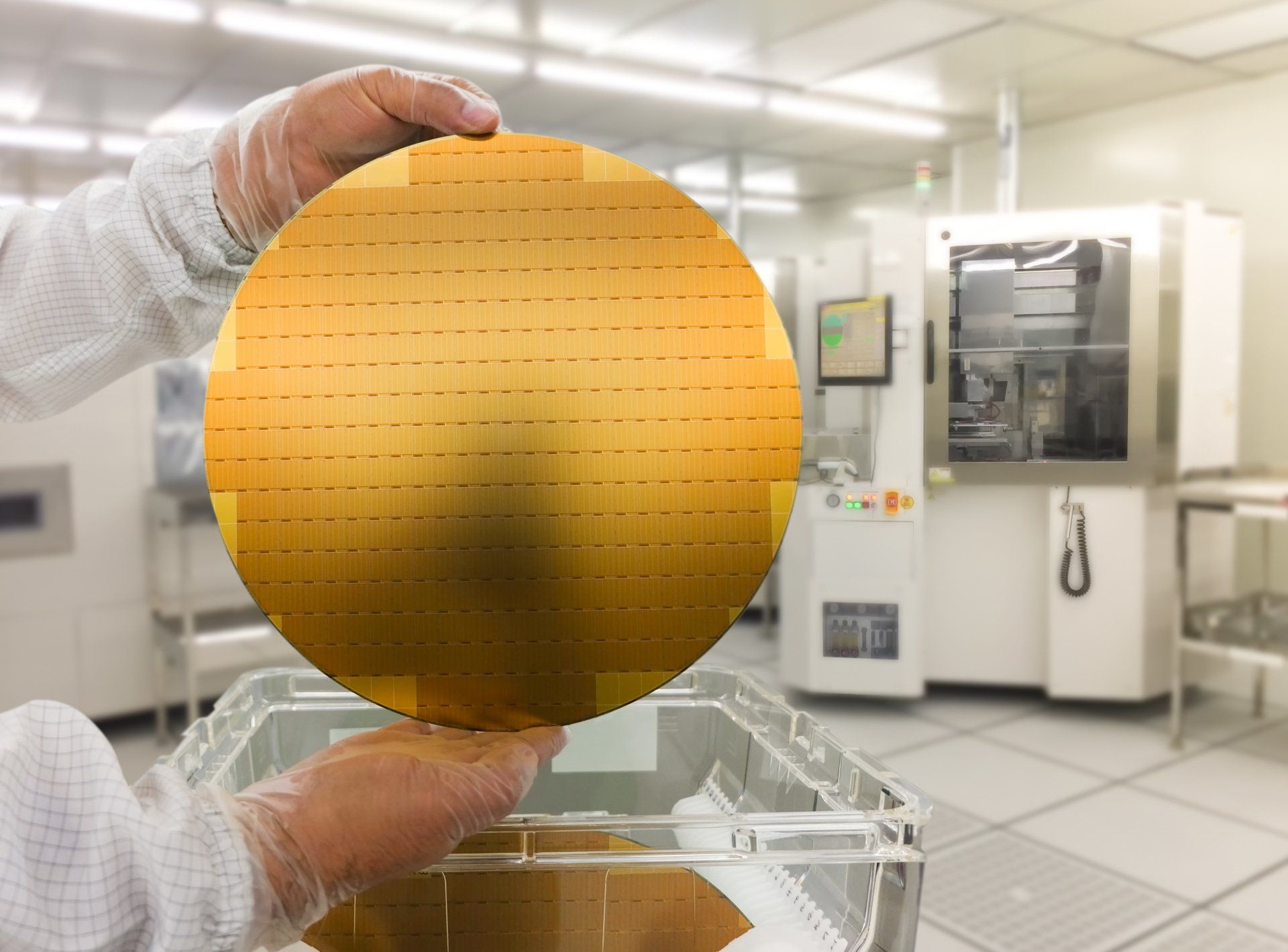A person is holding a yellow circle in their hand in front of a machine.