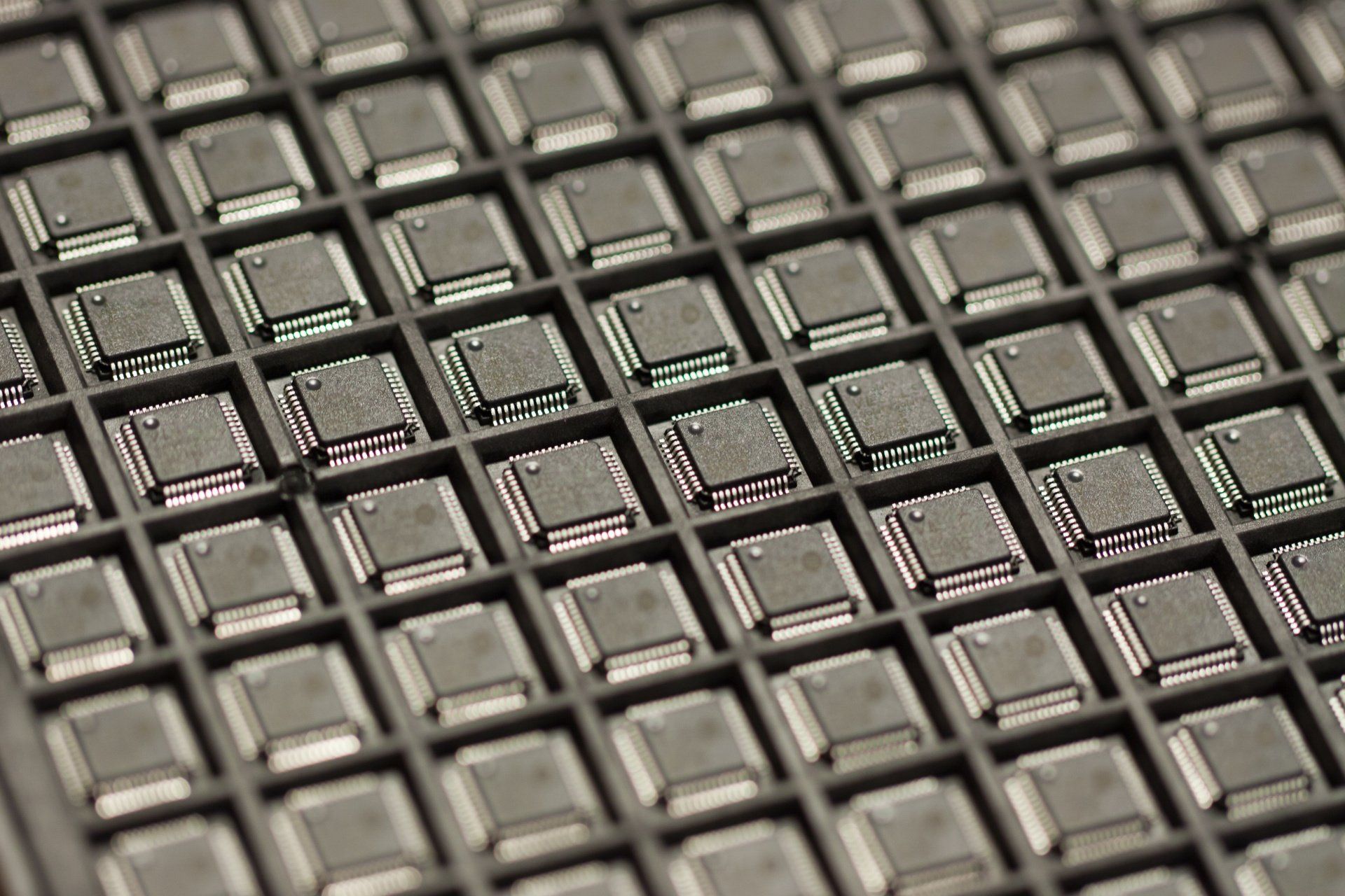 A close up of a black and red rubber mat with squares on it.