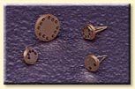 A group of nails are sitting on top of a purple surface.