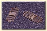 Two metal pieces are sitting on top of a purple surface.
