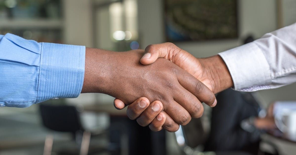 A group of construction workers are shaking hands with each other.