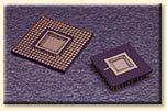 Two square chips are sitting on top of each other on a purple surface.