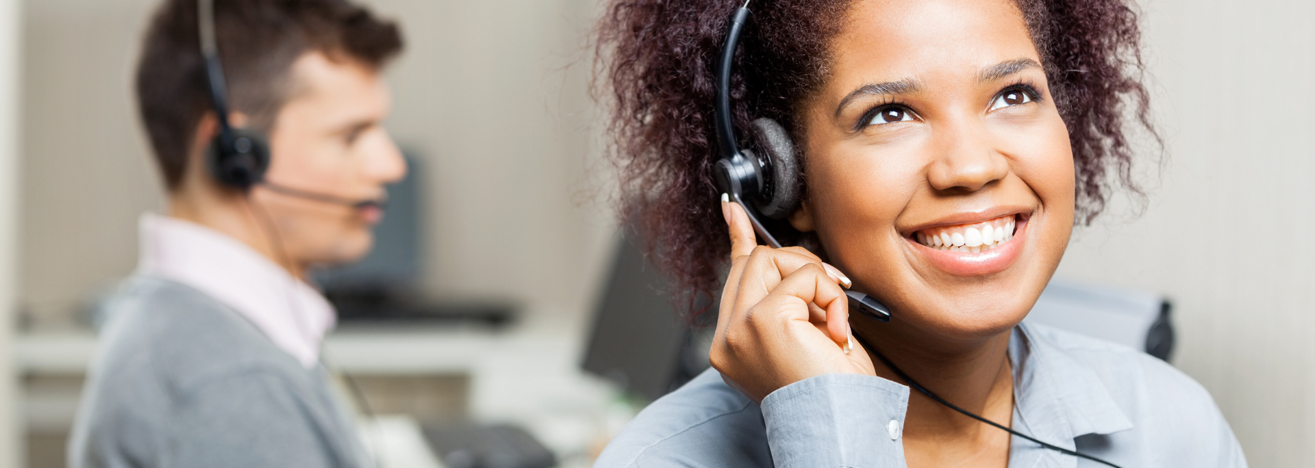 Picture of a contact centre worker looking happy on a call