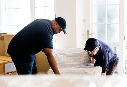 Affordable Movers — Two Workers Carrying Package in Greenville, SC