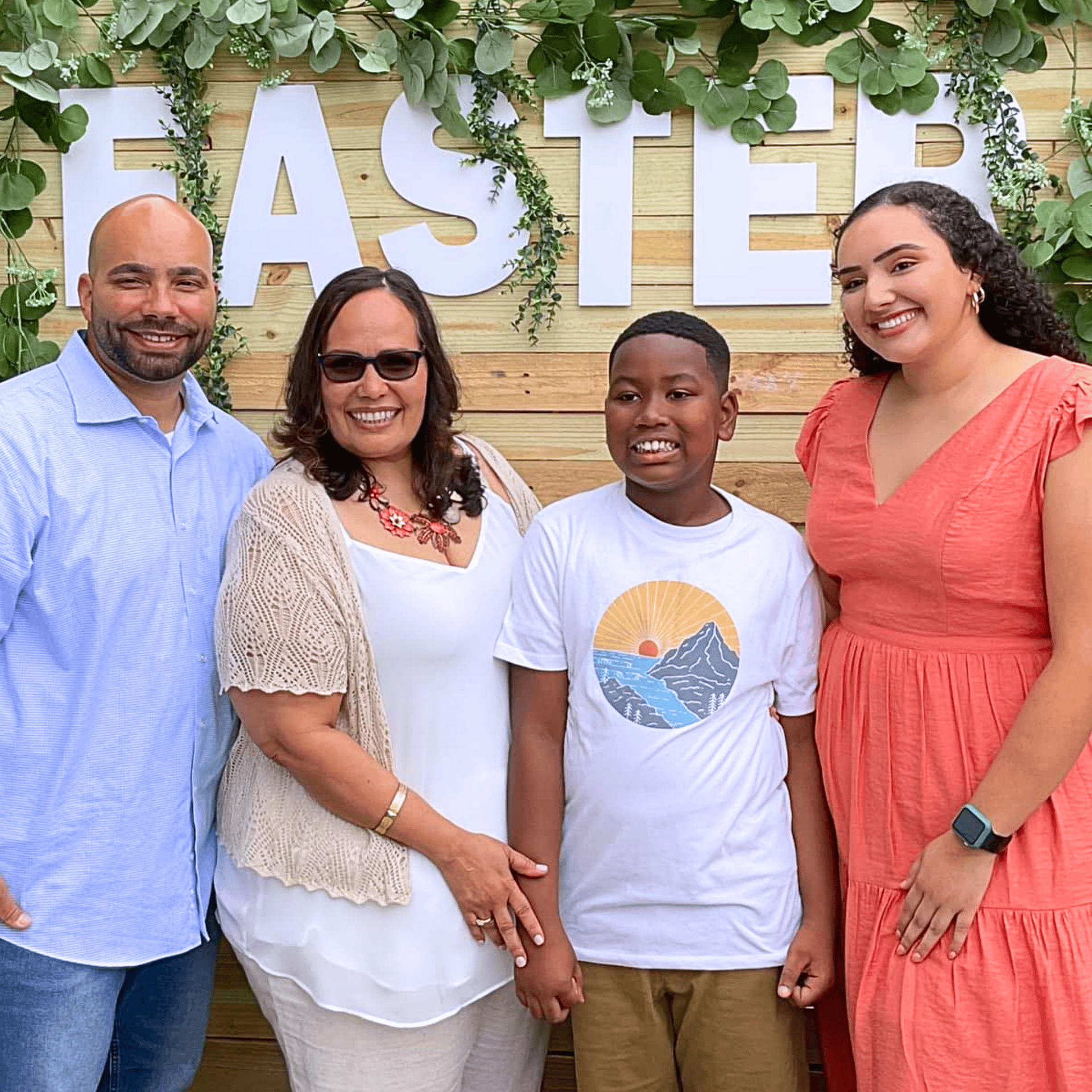 Family posing in front of a wooden backdrop with 