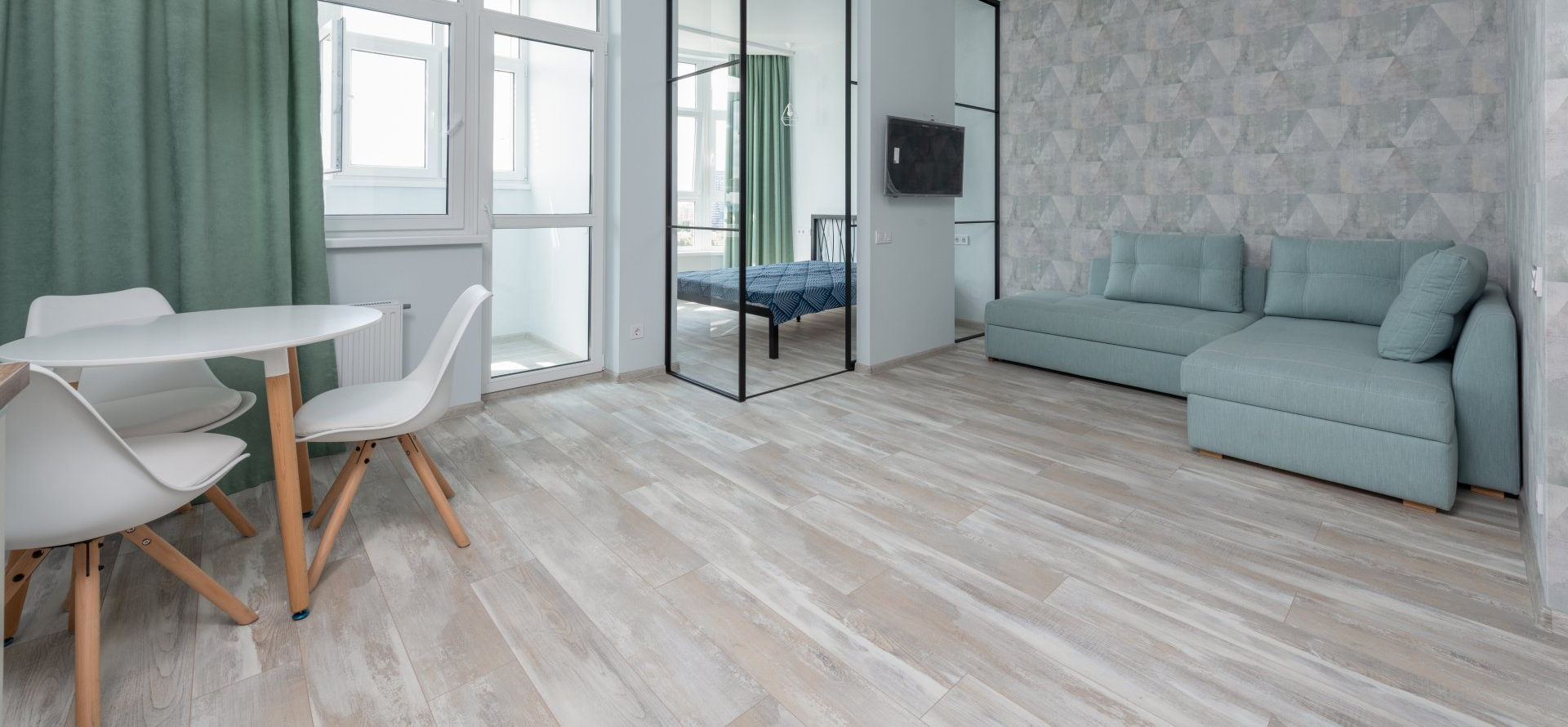 Picasso Frost Oak V-Groove laminate flooring in a modern Gauteng living room