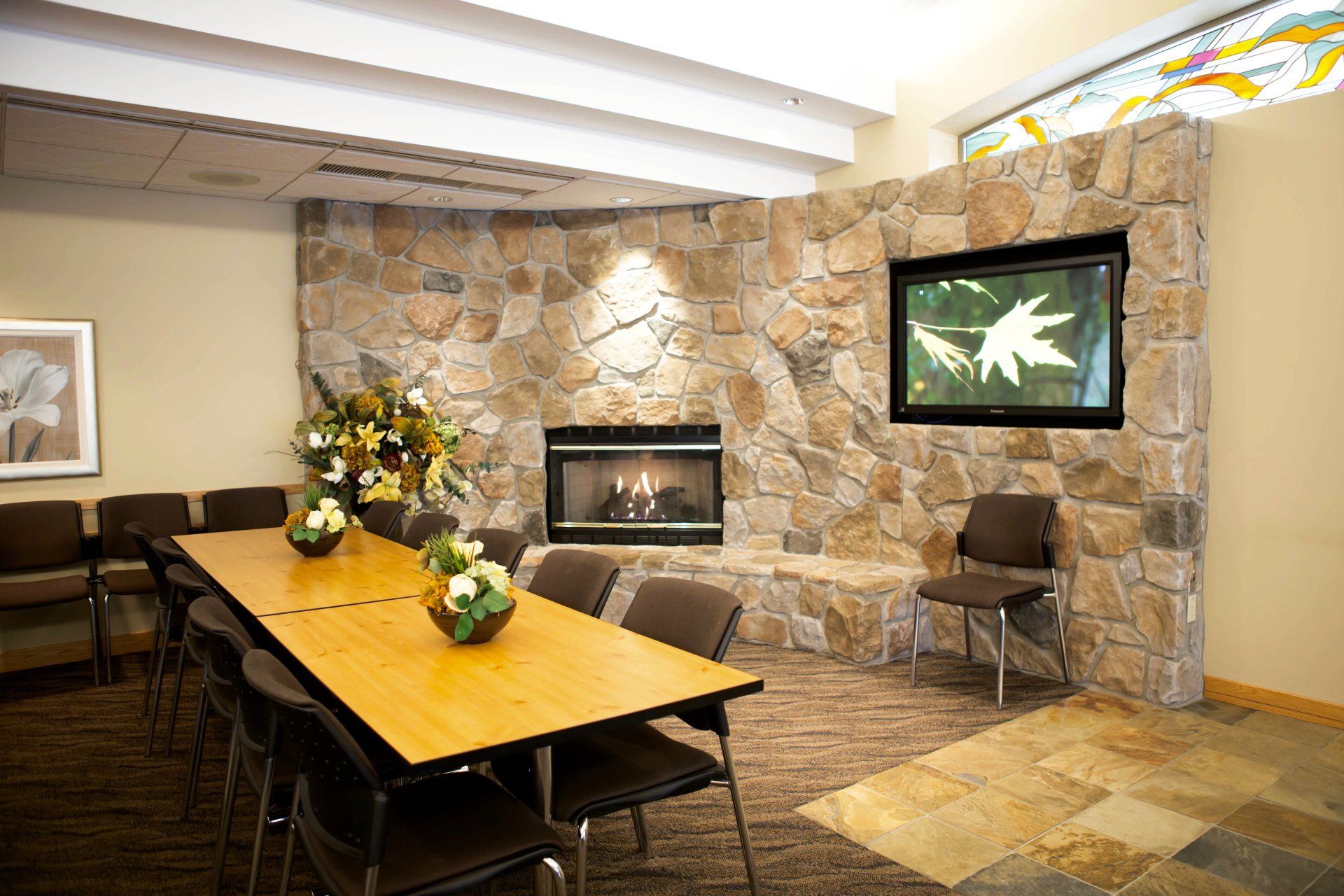 Left corner of Park Memorial Reception Centre interior, lit fireplace and multimedia screen in the background
