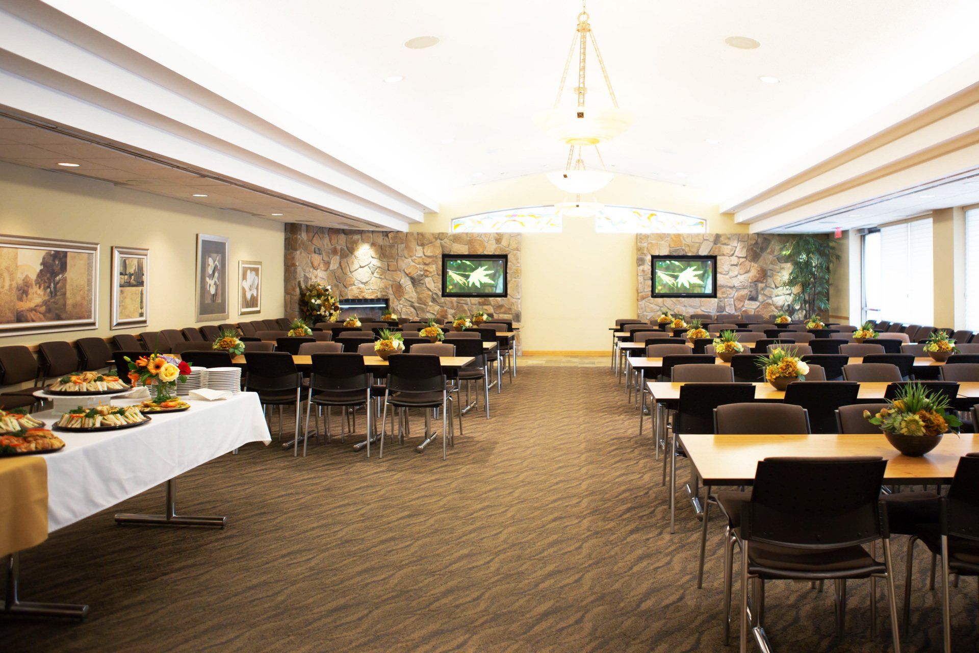 Spacious interior of the Park Memorial Reception Centre, food served to the left and organized tables to the right and back