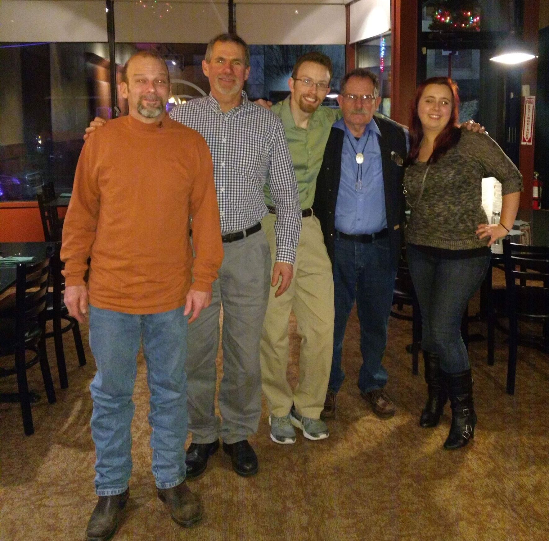 A group of people posing for a picture in a restaurant