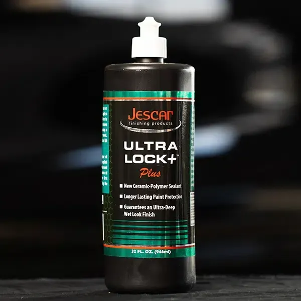 Bottle of Jescar Ultra Lock+ Plus car sealant with white pump cap against black background.