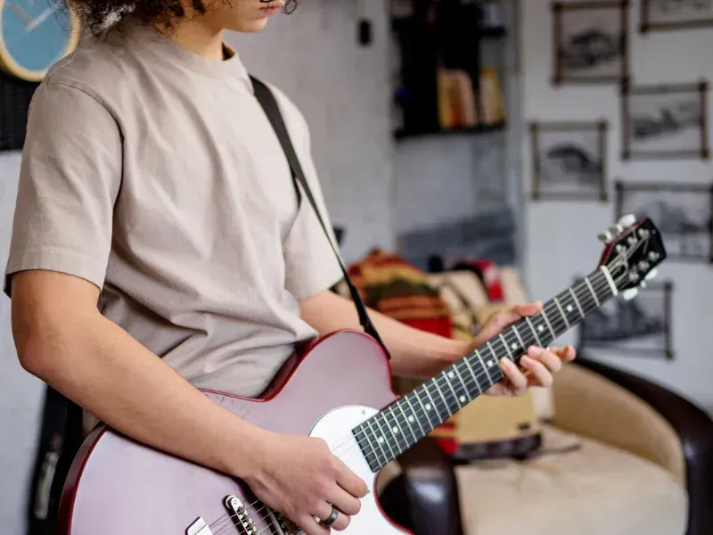 A person practicing on the electric guitar.