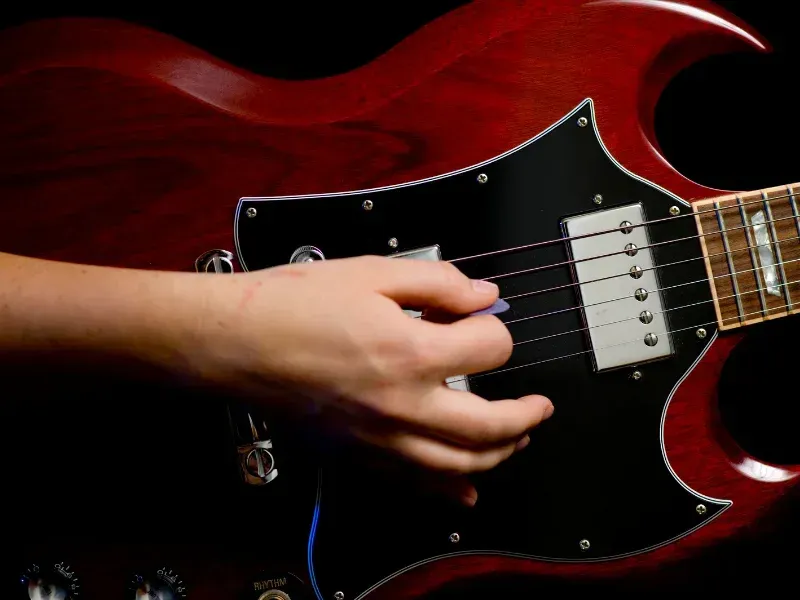 Image of electric guitar strumming.
