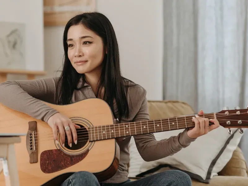 Image of a person learning their first guitar song.