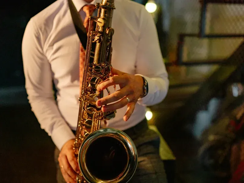 Image of a person playing the musical instrument: saxophone.