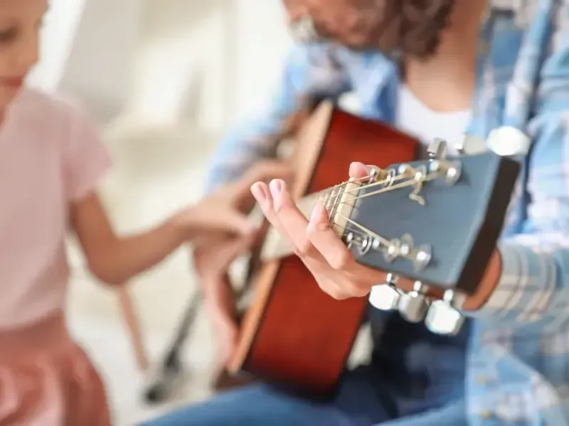 Image of a person talking to their music teacher.