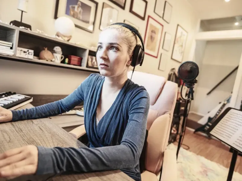 Image of a person with a headset on learning on the computer.