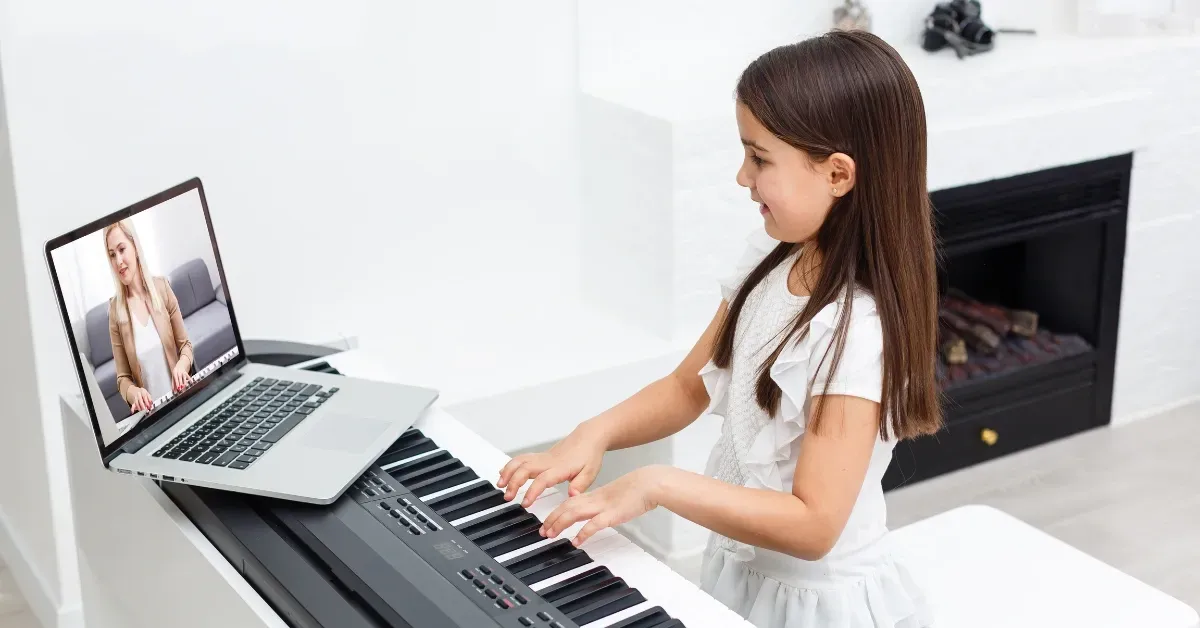 Image representing piano virtual lessons by showing a computer and a person learning piano with an i