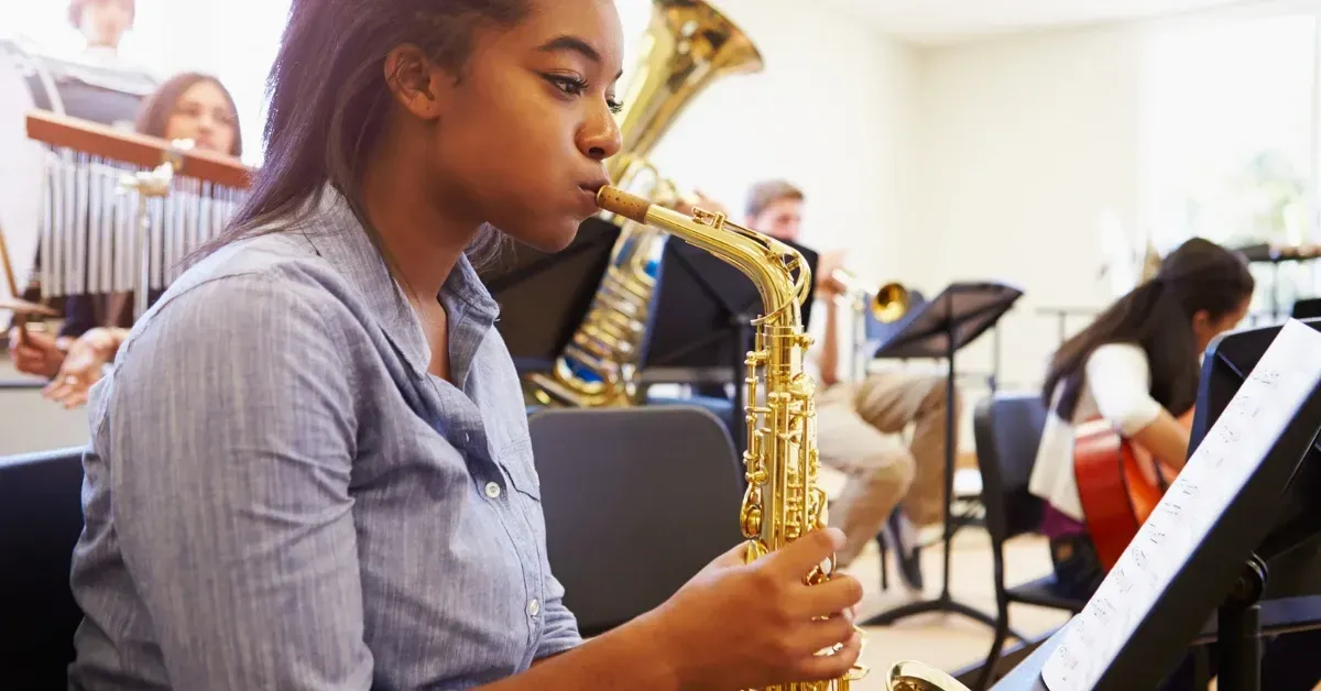 Image representing saxophone lessons beginners with a person learning saxophone with an instructor.