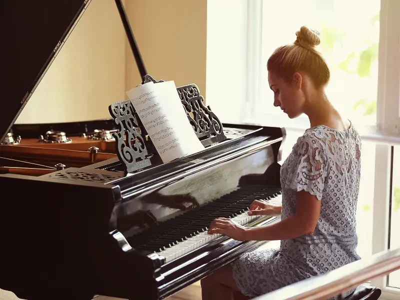Image of a person learning the piano.