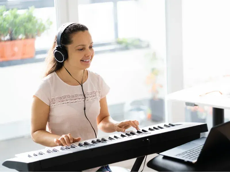 image of a person using the piano.