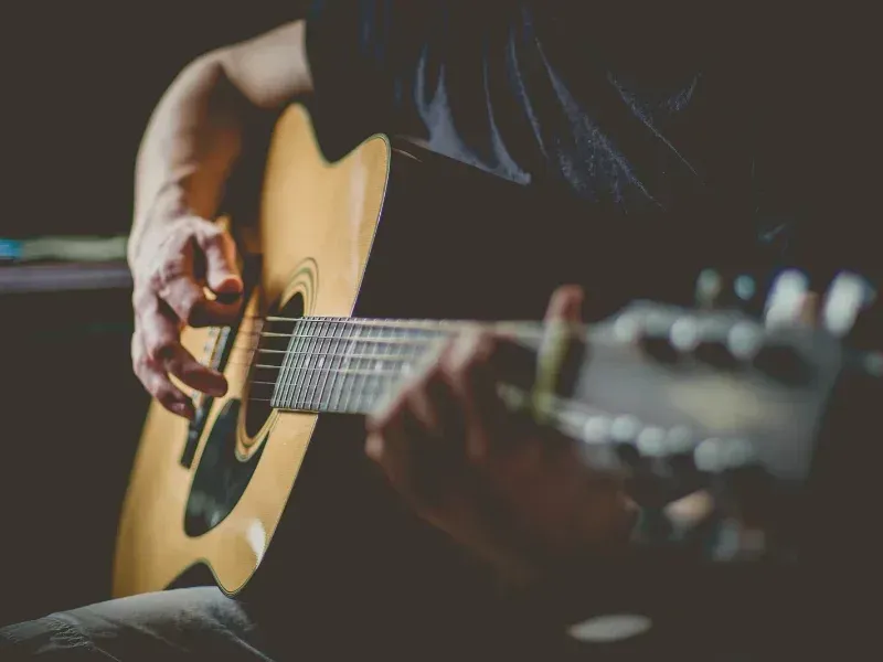Image of a person on an electric guitar.