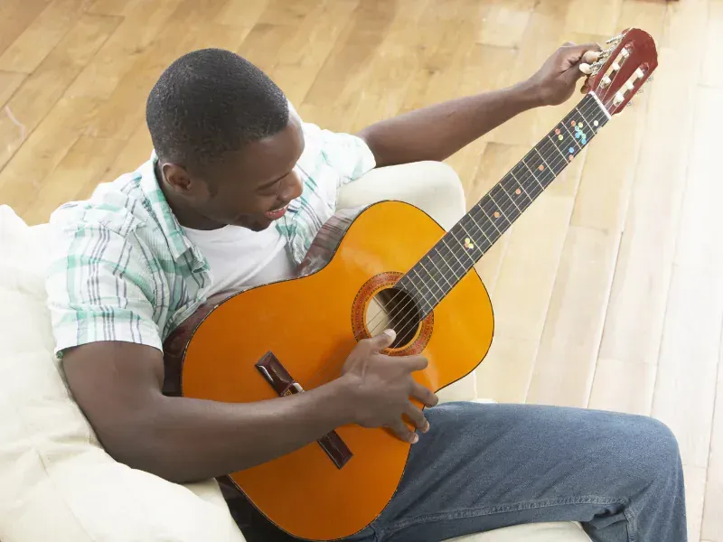 Image of a person practicing guitar.