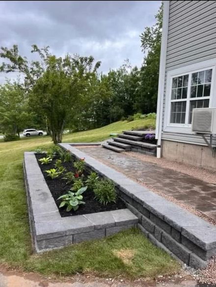back step with a retaining wall and flower bed behind a house