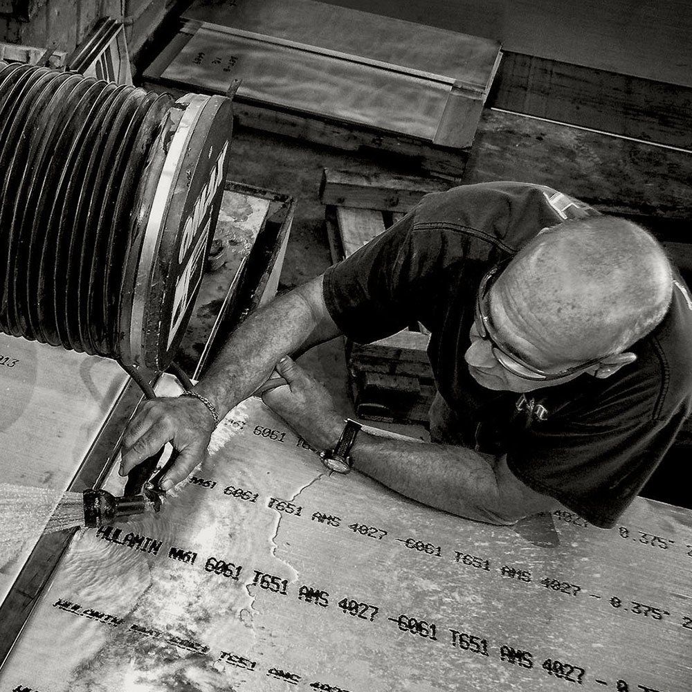image of a man using a large waterjet cutting machine
