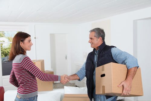 Lady shaking hand with professional mover