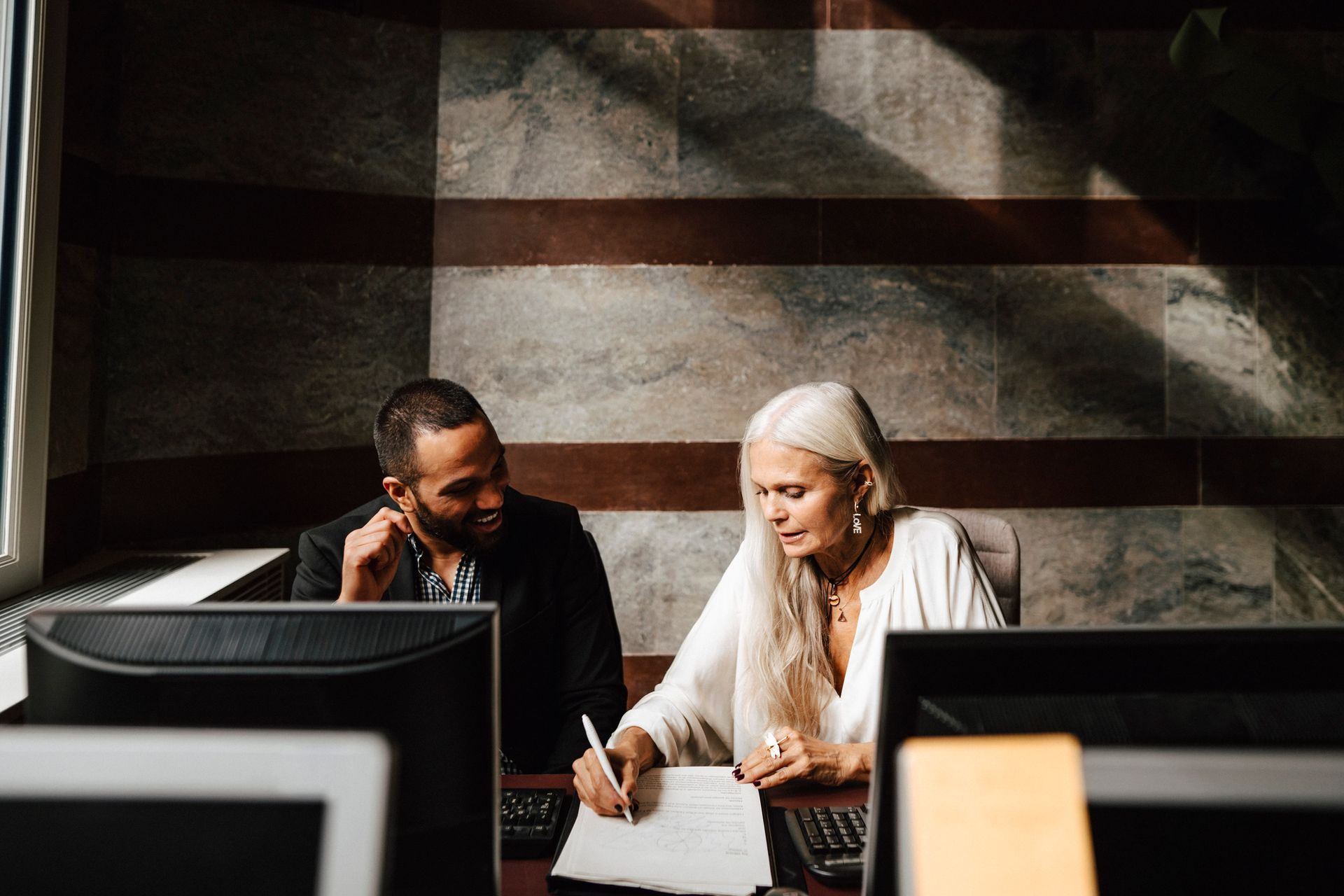A female accountant discussing financial plans with a male client.