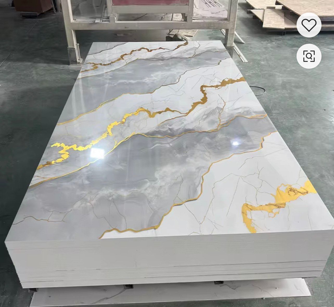 Modern living room with stone accent wall, white sofa, woven armchairs, and wooden stairs.