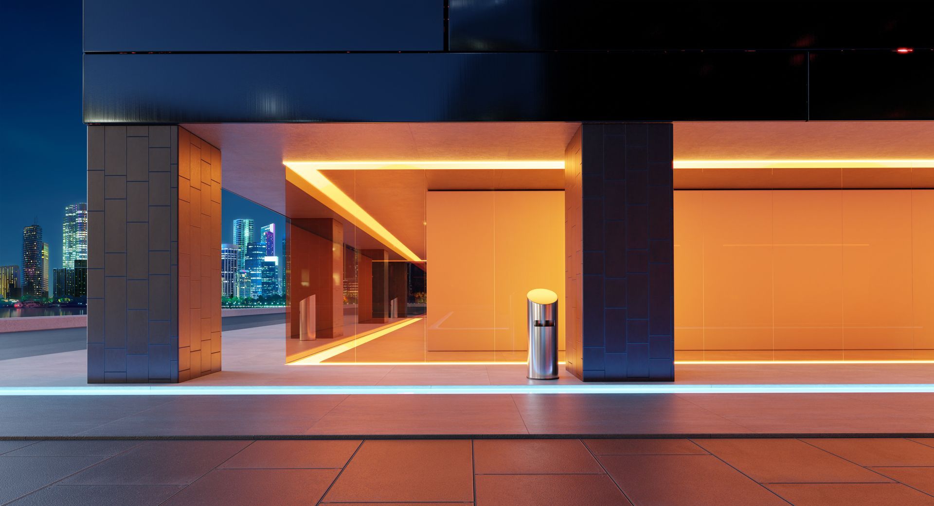Modern building entrance with orange lighting and a city skyline at dusk.