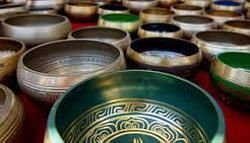 A bunch of bowls are sitting on top of each other on a table.