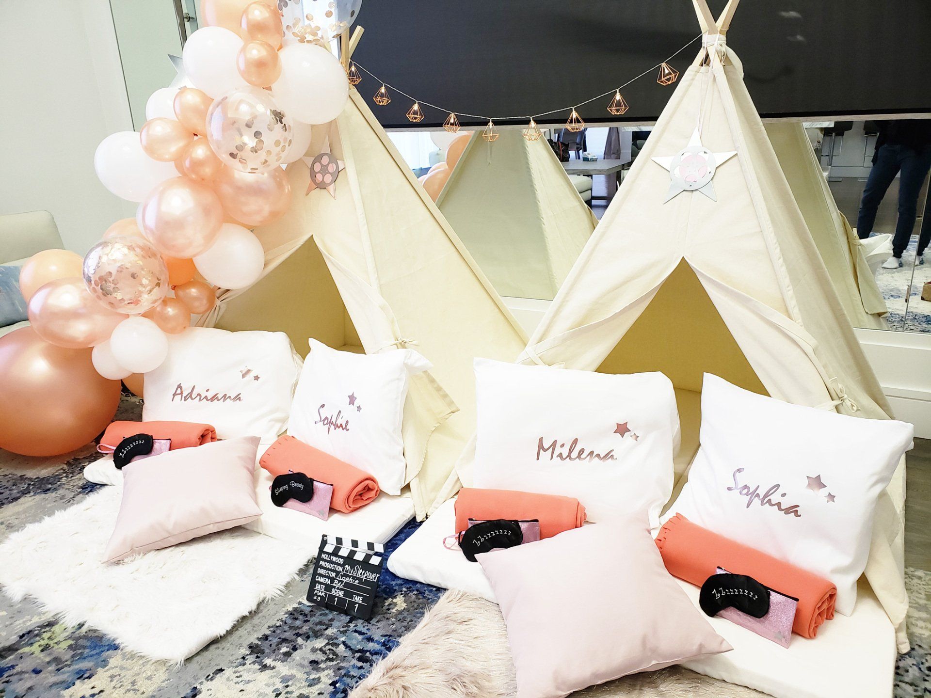 A group of teepees sitting on top of a rug with pillows and blankets.