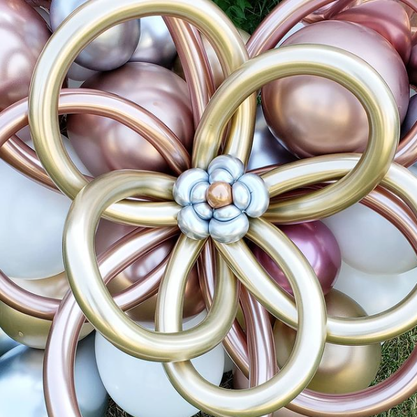 A close up of a flower made out of balloons