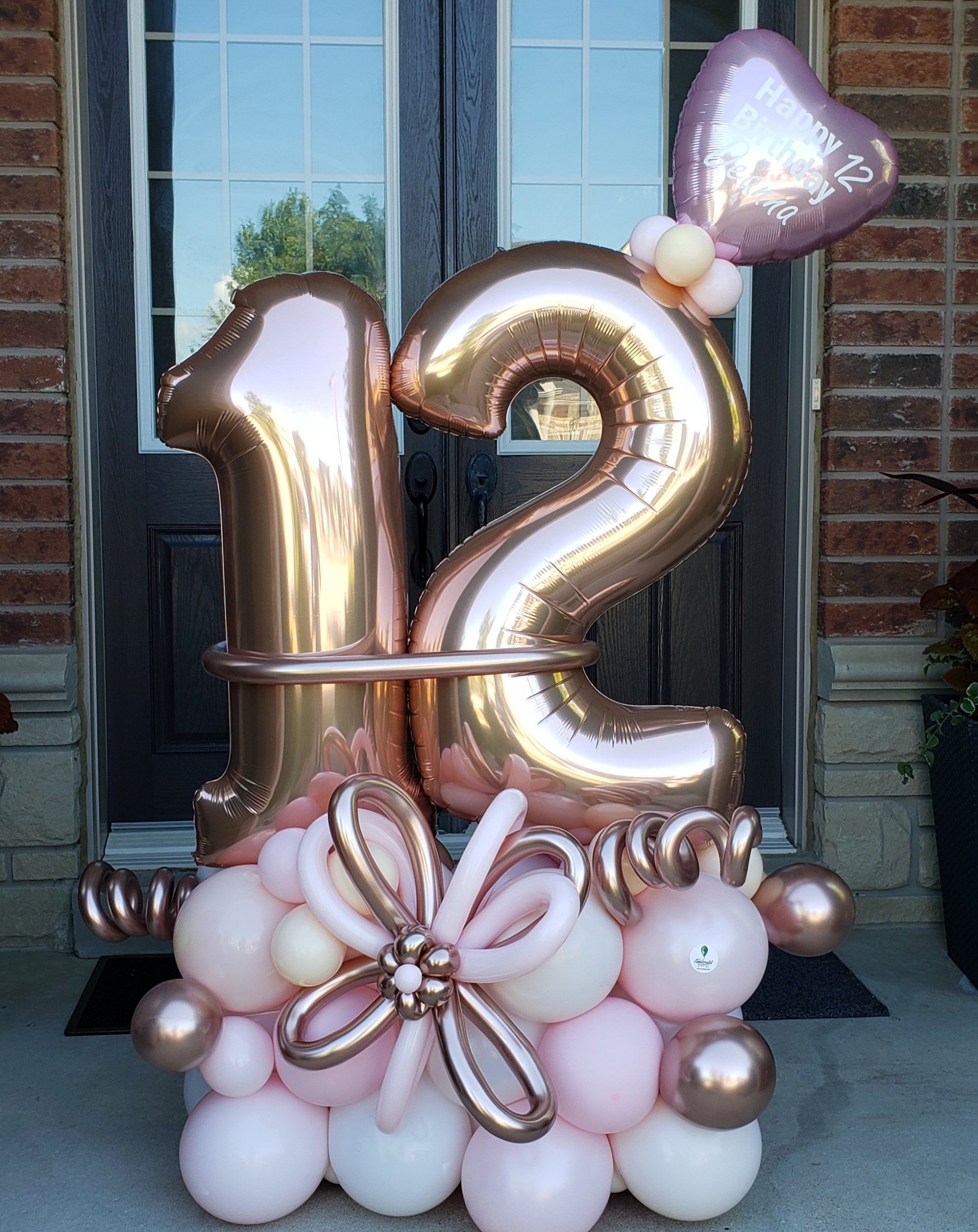 A bunch of balloons with the number 12 on them
