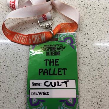 A green Spring Gathering event badge with 'The Pallet' printed on it and CULT handwritten over the top
