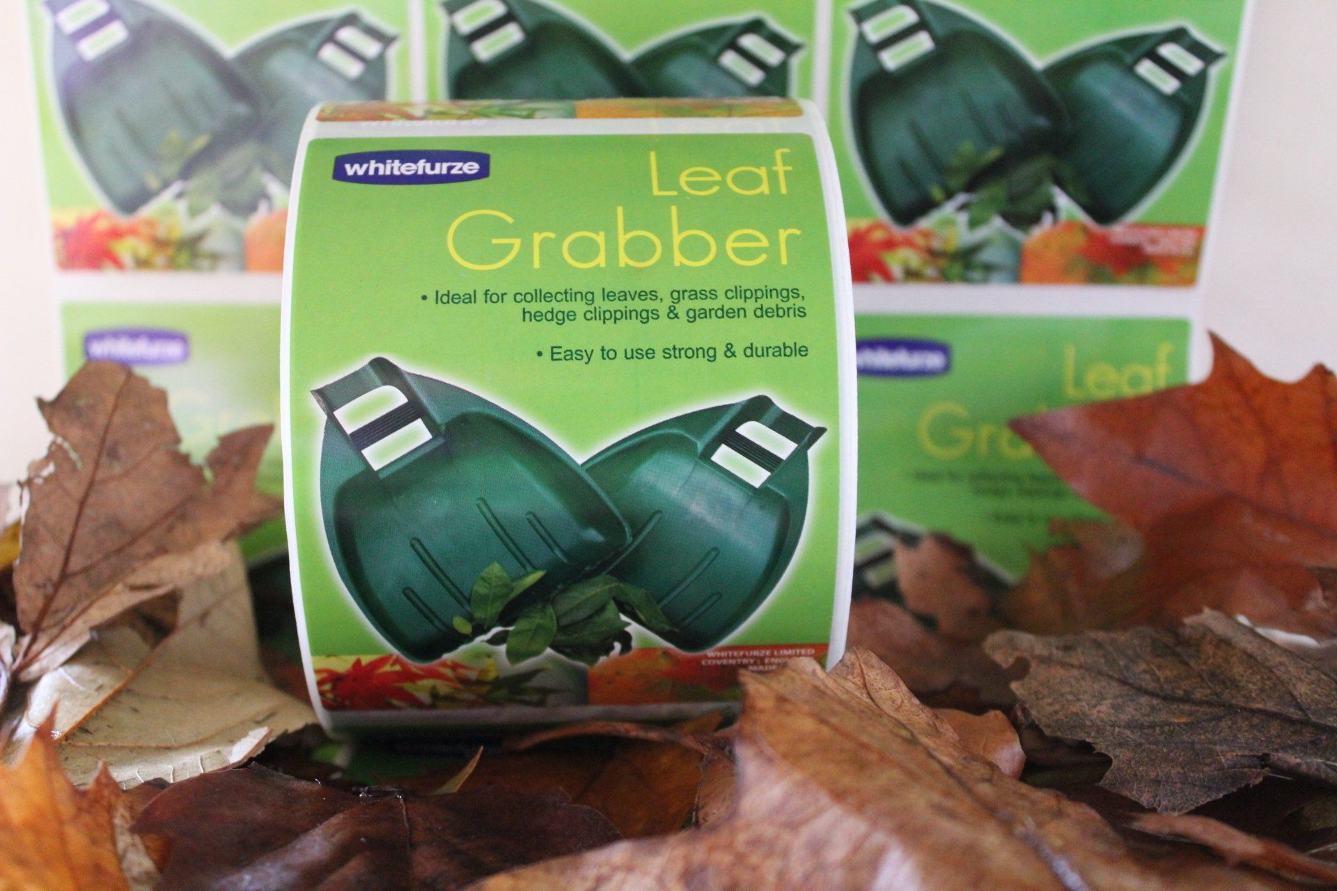 A collection of autumn leaves in front of reels of 'Leaf Grabber' labels