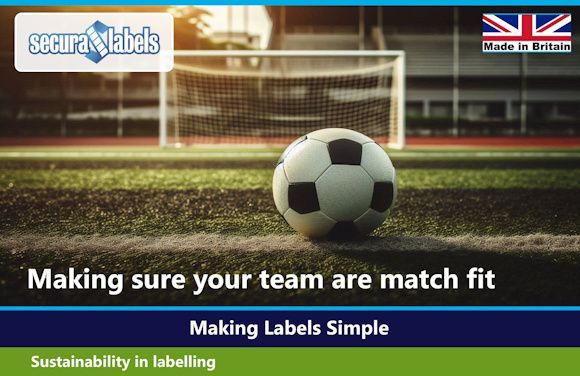 Match Ready Labels Promotional image for Secura Labels featuring a football sitting on the pitch in front of an open goal at sunset. The Secura Labels logo appears in the top left corner and a “Made in Britain” badge is in the top right. Large white text reads “Making sure your team are match fit” with the slogan “Making Labels Simple” underneath. A green banner at the bottom says “Sustainability in labelling.”