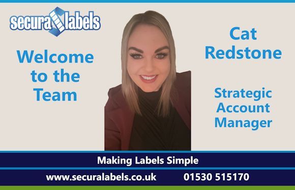 A smiling Cat Redstone wearing a black top and burgundy jacket looking directly at the camera