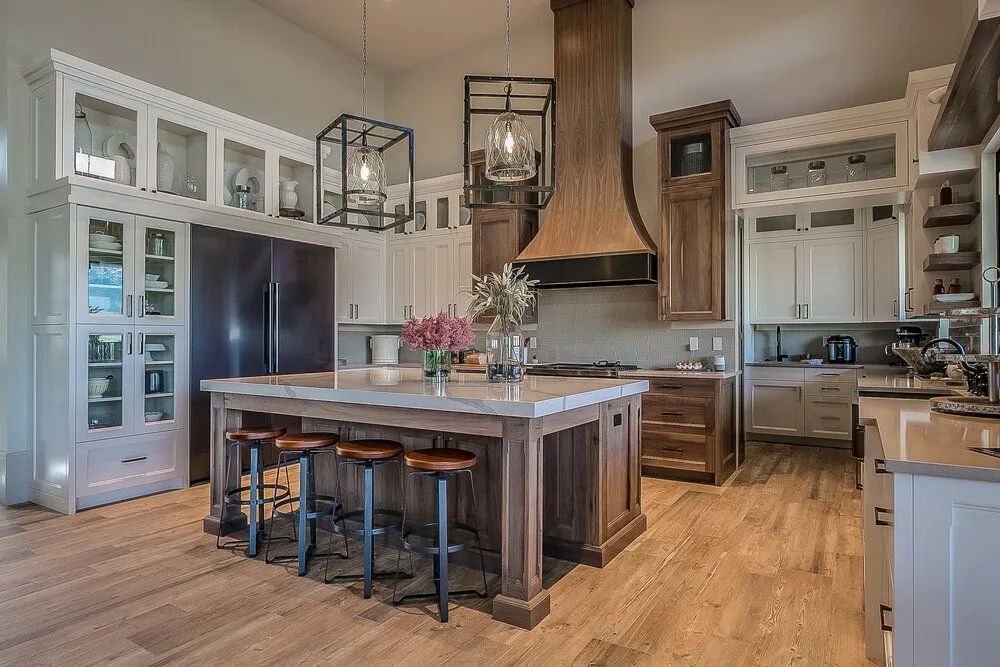 A large kitchen with a large island and stools.