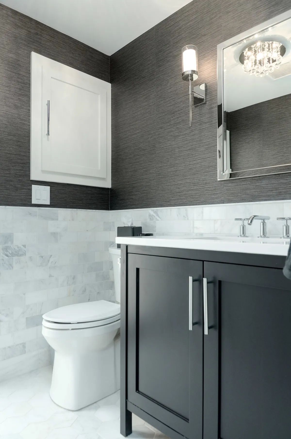 A bathroom with a toilet , sink and mirror