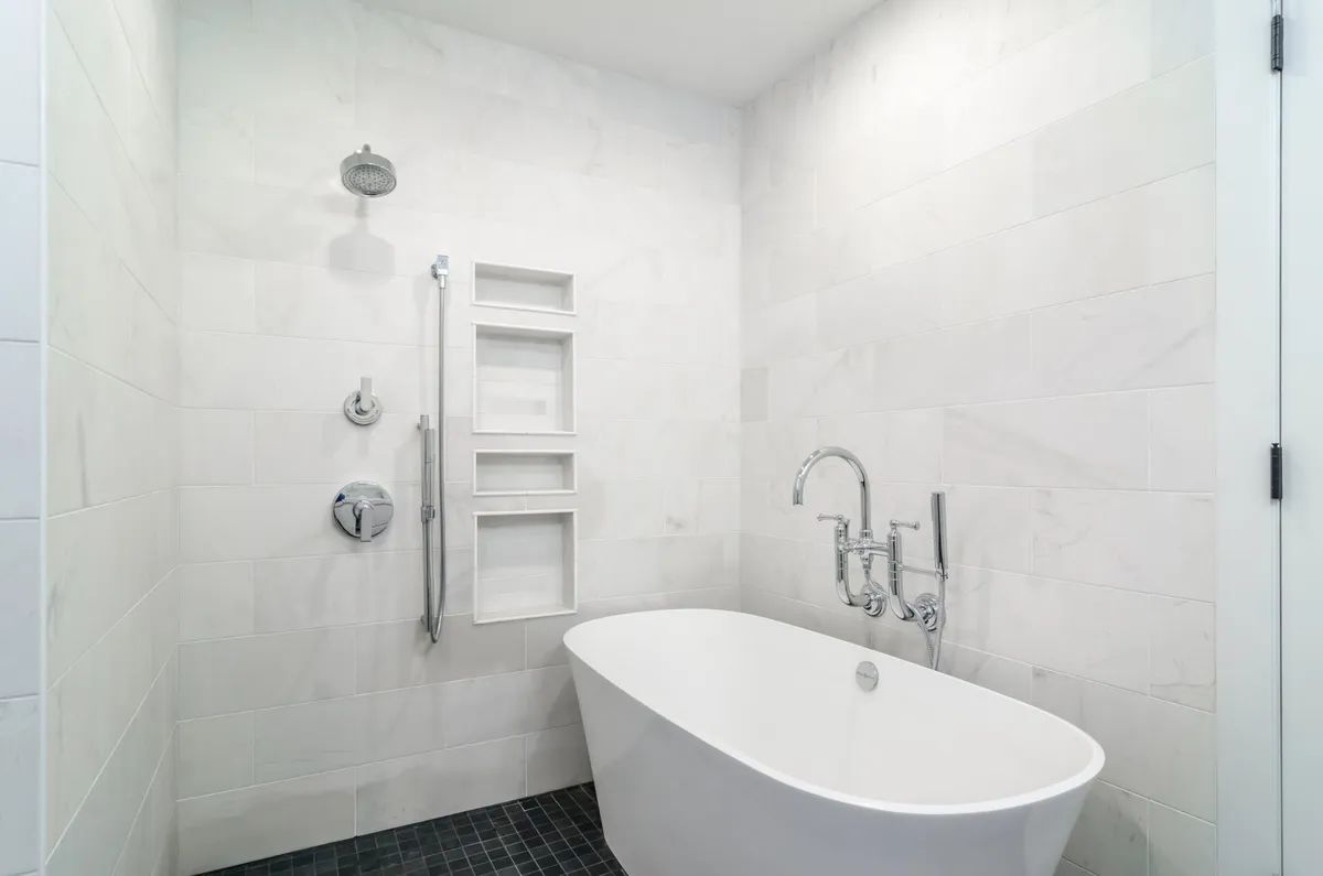 A bathroom with a bathtub and a walk in shower.