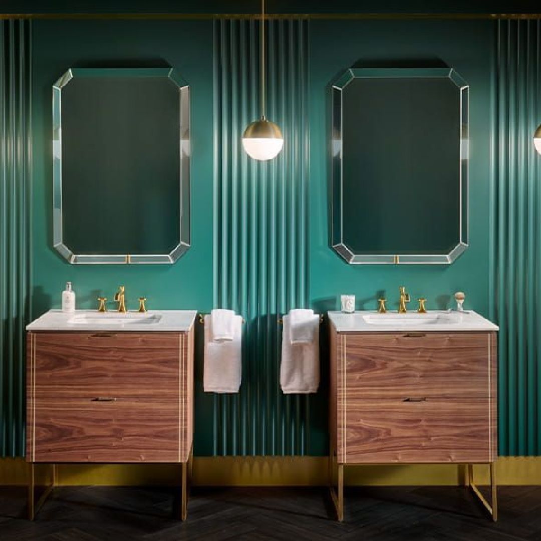 A bathroom with two sinks and two mirrors.