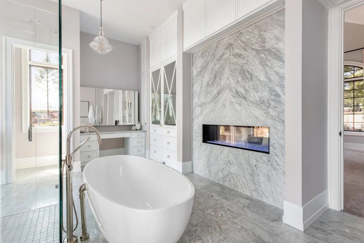 A bathroom with a tub and a fireplace.