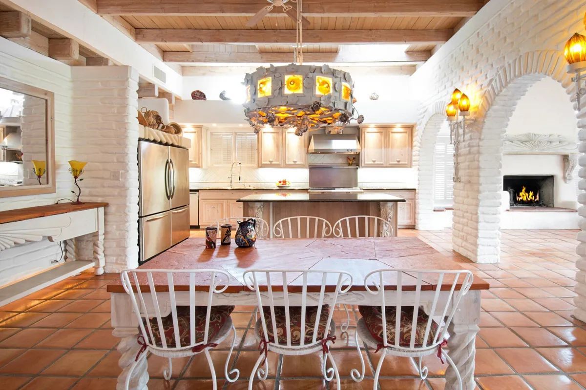 A kitchen with a table and chairs in it
