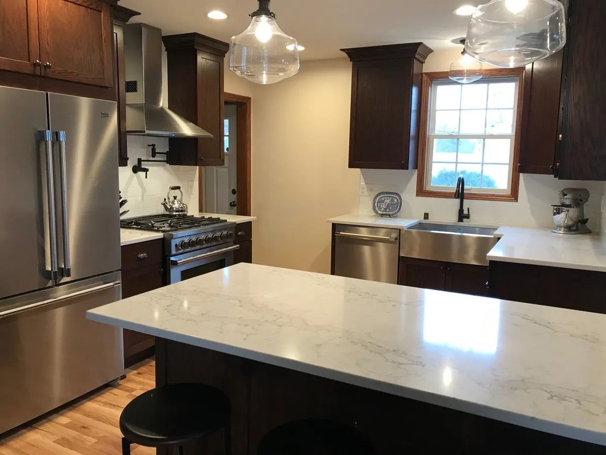 A kitchen with stainless steel appliances and a large island